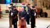 Britain's King Charles III, center, and other members of the royal family hold a vigil at the coffin of Queen Elizabeth II at St Giles' Cathedral, Edinburgh, Scotland, Sept. 12, 2022, as members of the public walk past.