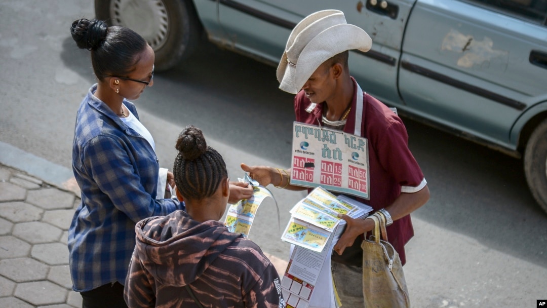 FILE - A vendor sells mobile phone credit cards on a street in Addis Ababa, Ethiopia, Nov. 3, 2022. Ethiopia, which had imposed internet shutdowns because of ethnic unrest in the country, recently lifted its restrictions.
