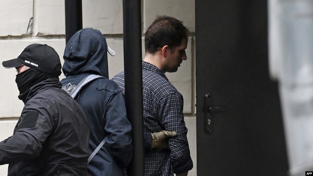 FILE - U.S. journalist Evan Gershkovich, right, is escorted outside the Lefortovsky Court in Moscow on Aug. 24, 2023.