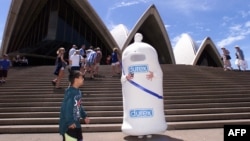 FILE - Safety Sam, The Condom Man, distributes free condoms on the steps of the Sydney Opera House, Feb. 20, 1999.