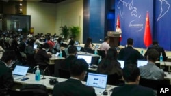 FILE - Foreign and local journalists attend the daily briefing at China's Ministry of Foreign Affairs office in Beijing, April 24, 2023.