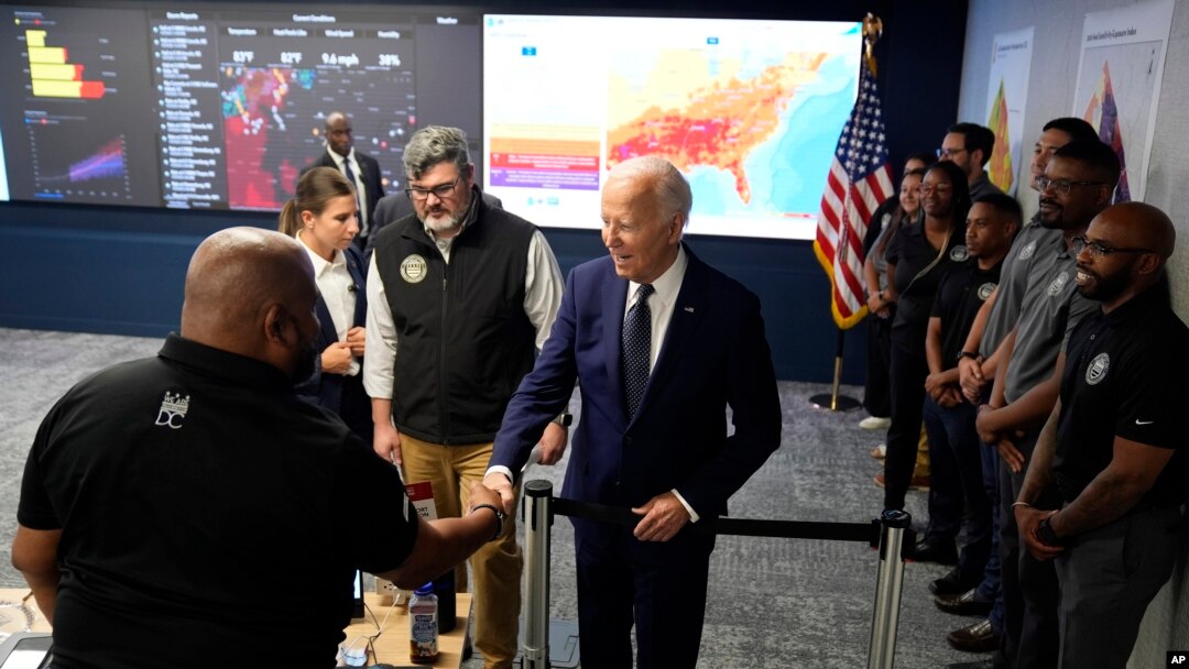 President Joe Biden greets people during a visit to the D.C. Emergency Operations Center, July 2, 2024, in Washington.