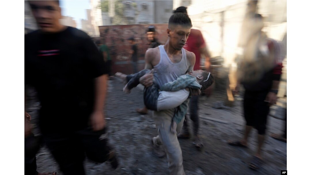 Palestinians evacuate survivors after Israeli airstrikes on buildings in Deir al Balah, Gaza Strip, Nov. 7, 2023.