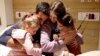 Aviv Asher, Raz Asher, and their mother Doron Asher meet with Yoni Asher, Raz and Aviv's father and Doron's husband, after returning to Israel at the Schneider Children's Medical Center, in Petah Tikva, Israel, in this handout picture released Nov. 25, 2023.