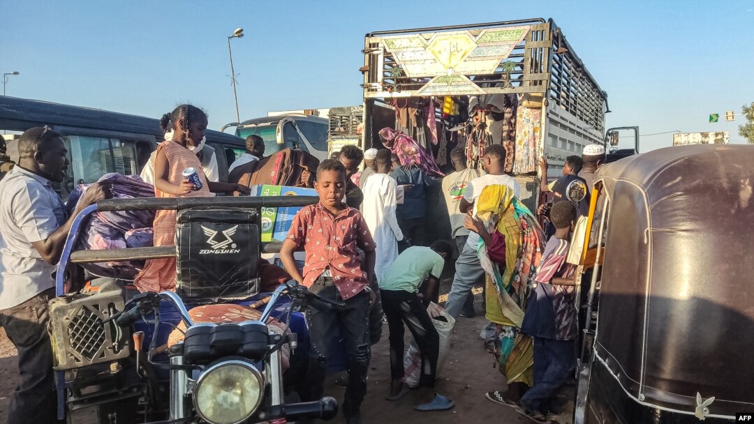 People displaced by the conflict in Sudan flee Wad Madani, the capital of al-Jazirah state, heading to Gadaref state on Dec. 16, 2023. 