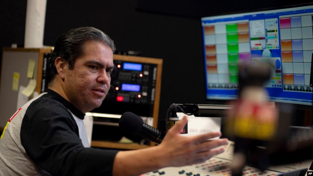 Host Tony "El Tigre" Arias speaks during a broadcast at the Phoenix studio of Radio Campesina, a Spanish-language network, March 21, 2024. The network is battling misinformation being aimed at voters ahead of the fall U.S. presidential election.