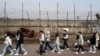 FILE - People pass by a wire fence at the Imjingak Pavilion in Paju South Korea, near the border with North Korea, March 24, 2023. 