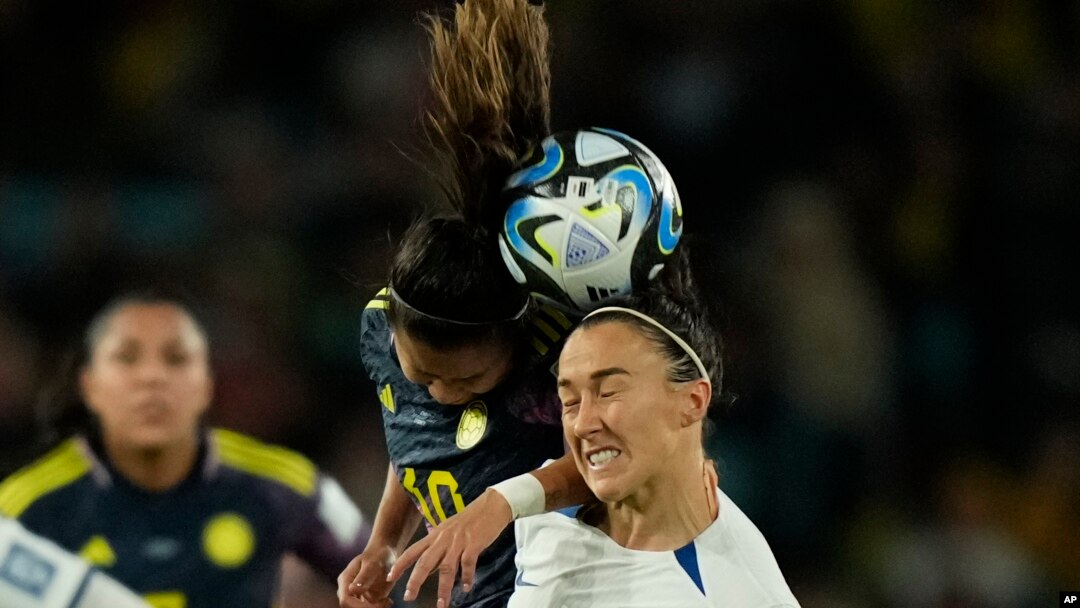 Colombia's Leicy Santos and England's Lucy Bronze jump for the ball during a Women's World Cup quarterfinal soccer match in Sydney on Aug. 12, 2023.