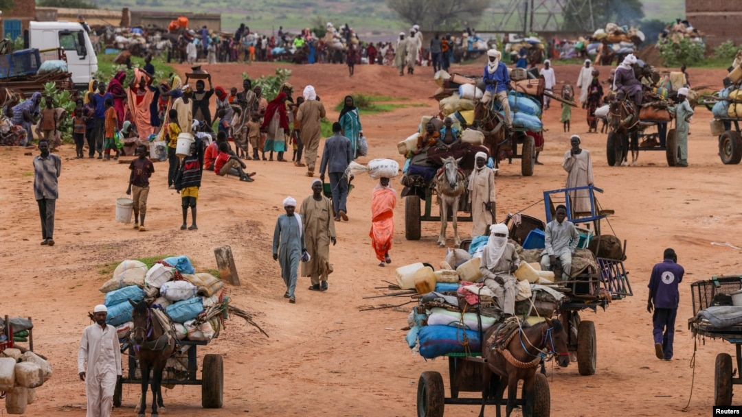 FILE - People fleeing the violence in West Darfur, cross the border into into Chad, Aug. 4, 2023.