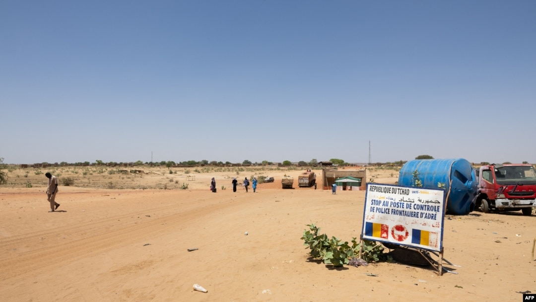 FILE - People cross the border between Sudan and Chad at a post in Adre on April 11, 2024. Officials say an influx of refugees, armed conflicts, climate change, floods, droughts and agricultural disasters have led to unprecedented food insecurity in Chad.