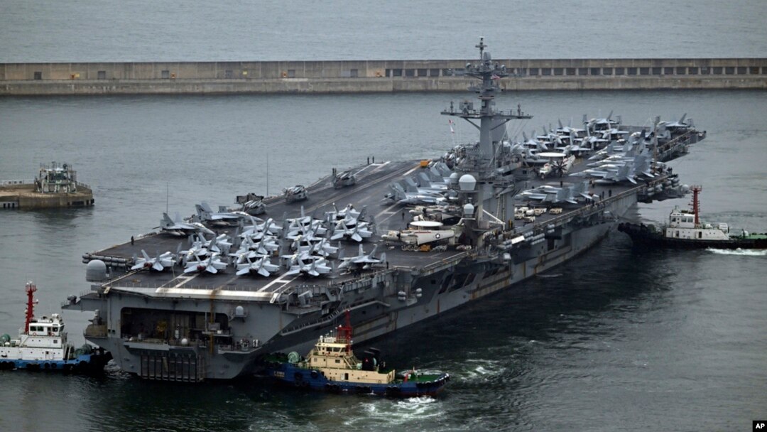 The USS Theodore Roosevelt (CVN 71), a nuclear-powered aircraft carrier, is anchored in Busan, South Korea, June 22, 2024. 