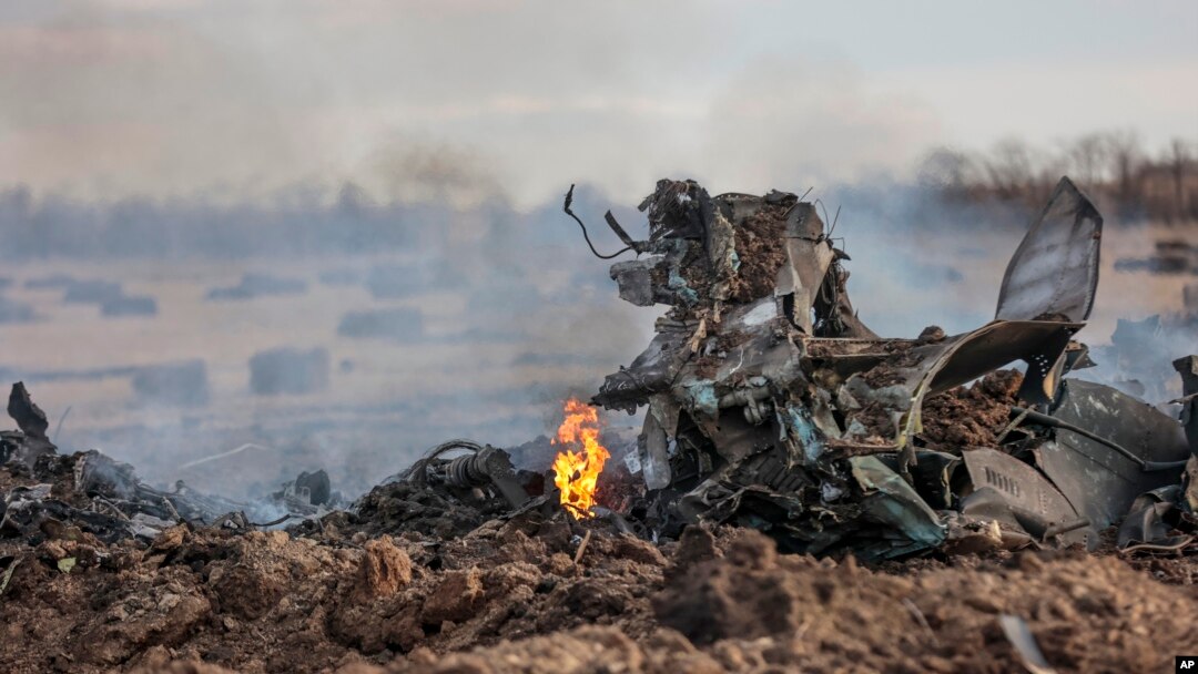 The wreckage of ta warplane burns after it crashed near Yenakijeve, Russian-controlled Donetsk region, eastern Ukraine, Friday, March 3, 2023.