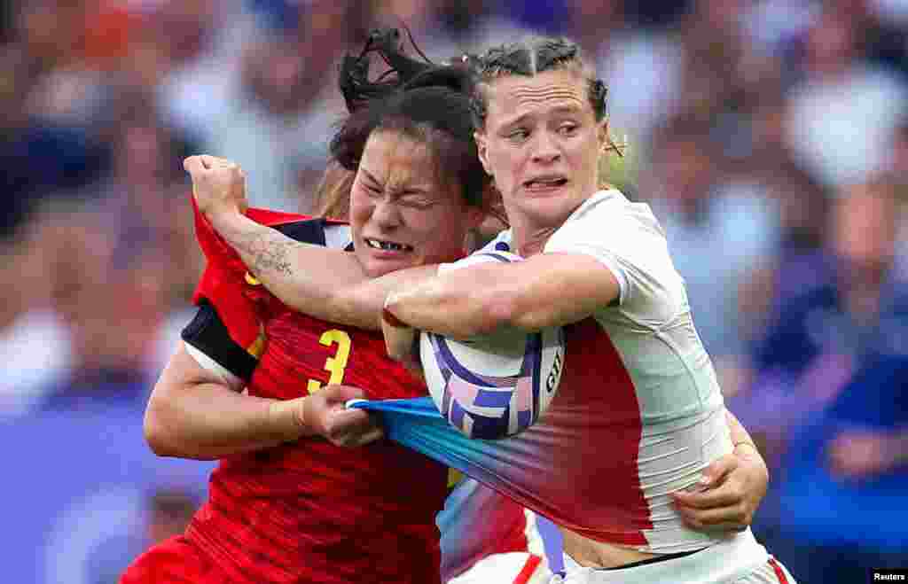 Lou Noel of France, right, is tackled by Qi Su of China, left, during the women's placing 5-6 Rugby Sevens match between China and France at the 2024 Summer Olympics in the Stade de France.