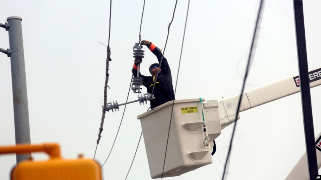 Utility crews work to restore electricity in Houston, July 11, 2024. 