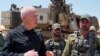 FILE - Israeli Defense Minister Yoav Gallant stands with soldiers by a self-propelled artillery howitzer during a visit to a position along the border with the Gaza Strip in southern Israel near Rafah, May 7, 2024. (Photo by Israeli Army/AFP) 