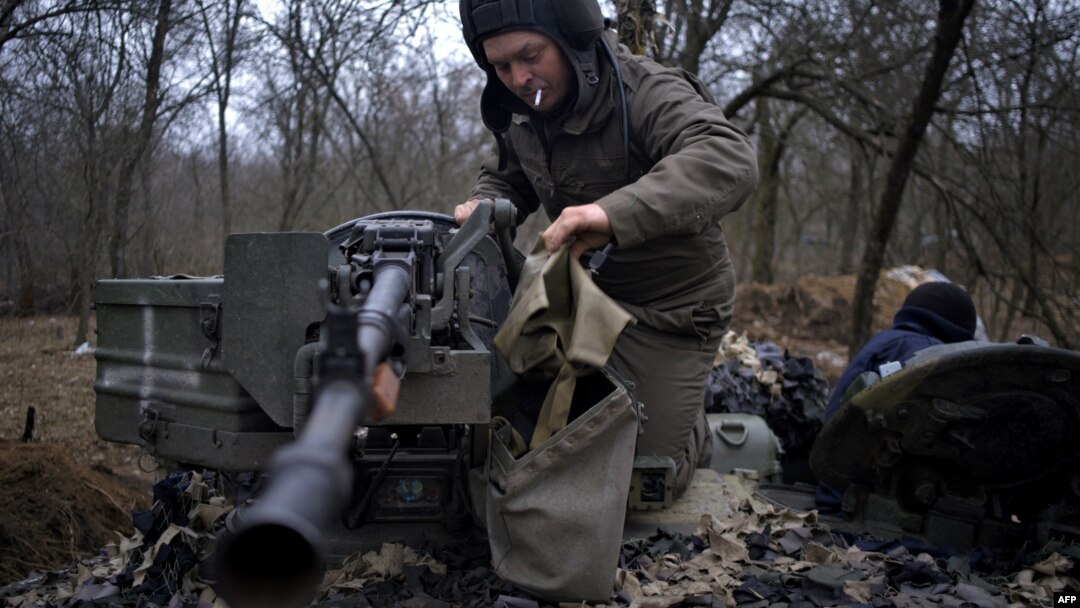 A Ukrainian serviceman of "Adam" tactical group prepares a T-64 tank to move to the positions on the front line near Bakhmut, on March 19, 2023, amid the Russian invasion of Ukraine. 