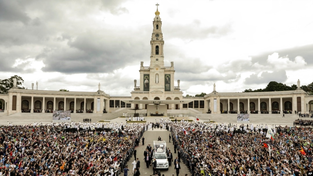 FILE - Pope Francis in his popemobile leaves at the end of a Mass where he canonized shepherd children Jacinta and Francisco Marto at the Sanctuary of Our Lady of Fatima, May 13, 2017, in Fatima, Portugal. 