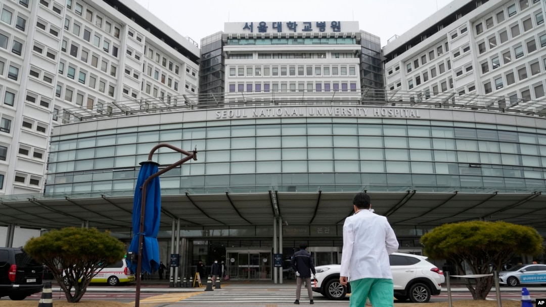 A medical worker walks to enter Seoul National University Hospital in Seoul, South Korea, Feb. 29, 2024. South Korea’s government made a last appeal to junior doctors to end a walkout, with hours left to go before the Thursday deadline.