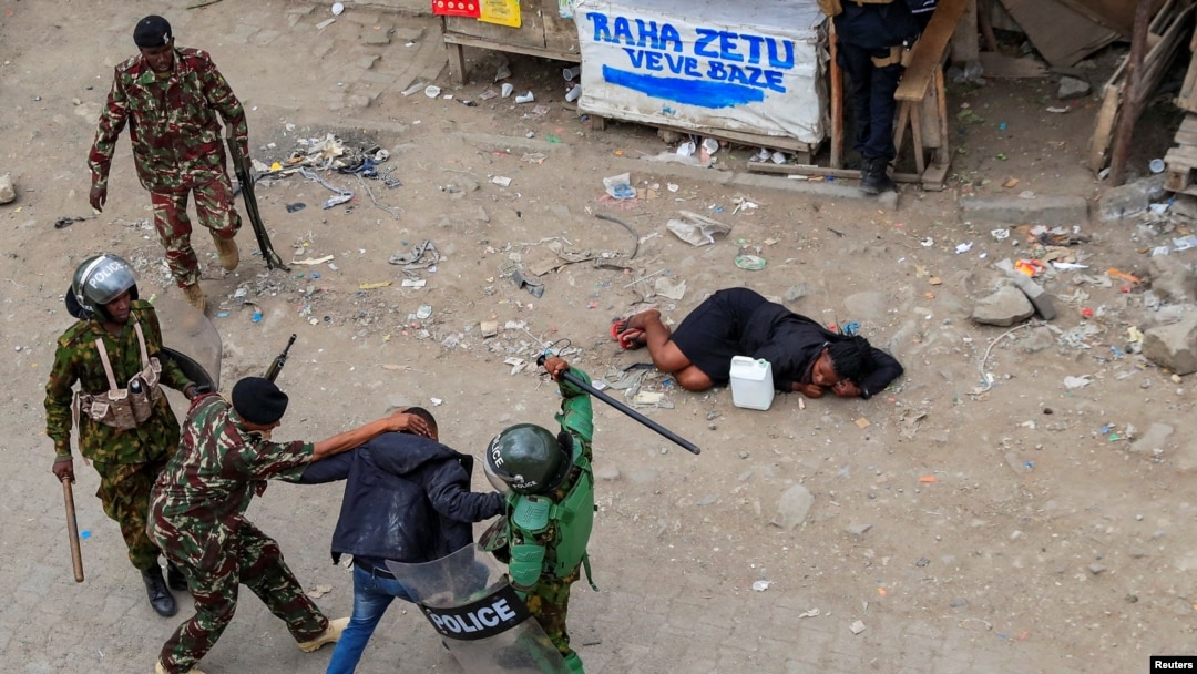 FILE - Riot police accost a supporter of Kenya's opposition leader Raila Odinga during an anti-government protest against the imposition of tax hikes by the government, in Mlolongo settlement of Machakos county, July 12, 2023.