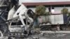 FILE - A Thai officer stands beside a burned-out oil tanker at a gas station in Pattani province, southern Thailand, Aug. 17, 2022. Thailand’s southernmost provinces have been the scene of an active Muslim separatist insurgency for almost two decades. 
