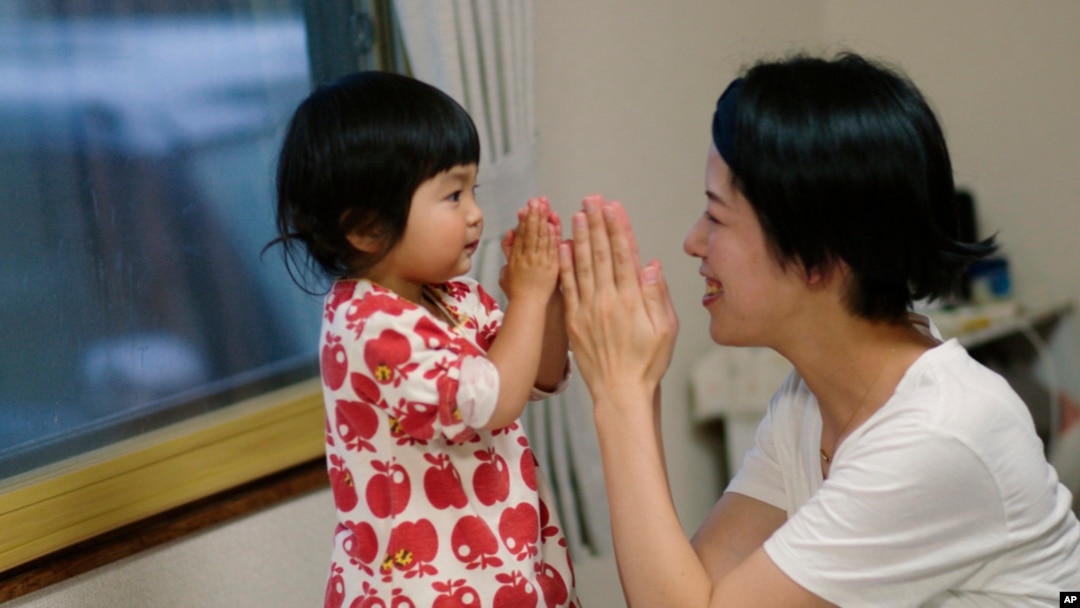 This photo provided by Japan Media Services shows a scene from 'The Ones Left Behind: The Plight of Single Mothers in Japan,' directed by Rionne McAvoy.
