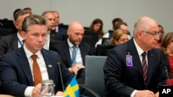 Swedish Defense Minister Pal Jonson, left, and Turkish Defense Minister Yasar Guler attend a meeting of the Ukraine Defense Contact Group at NATO headquarters in Brussels, June 15, 2023.