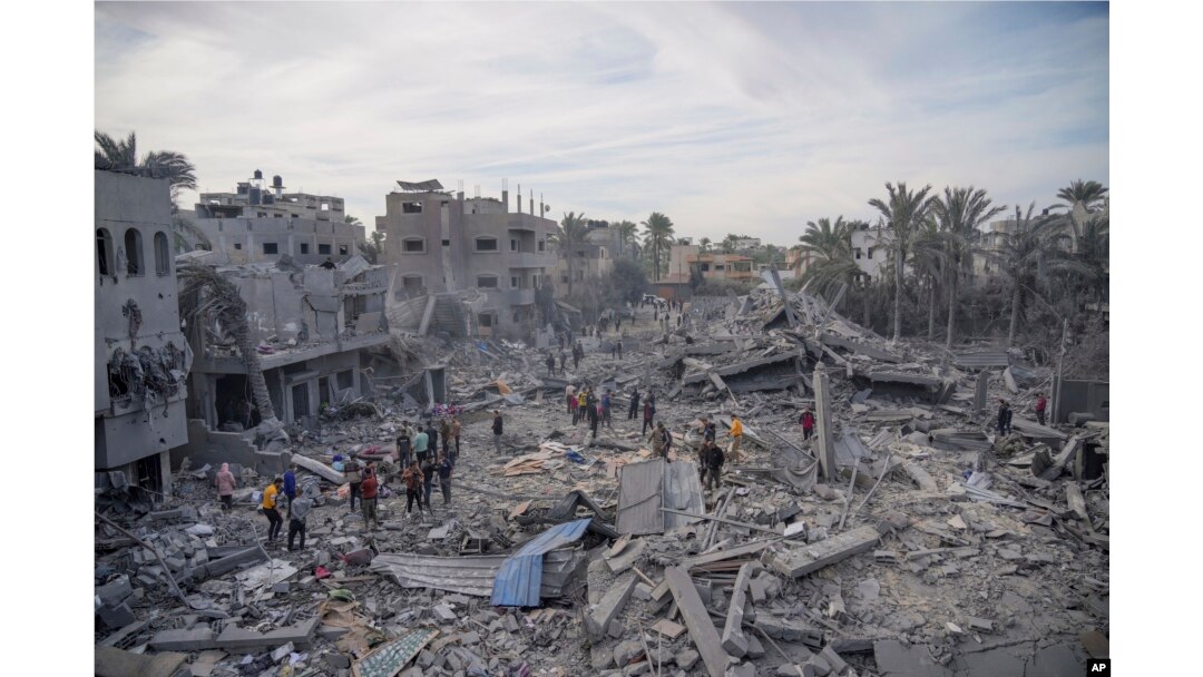 Palestinians look at destruction by the Israeli bombardment of the Gaza Strip, in Deir al Balah, Nov. 22, 2023.