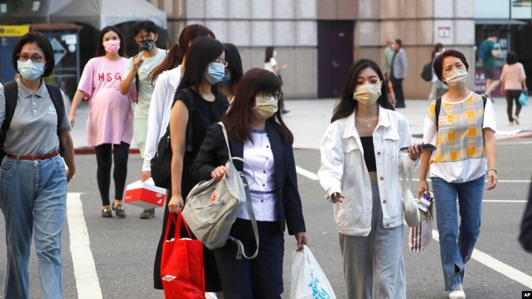 People wear face masks to protect against the spread of the coronavirus in Taipei, Taiwan, Aug. 31, 2022.