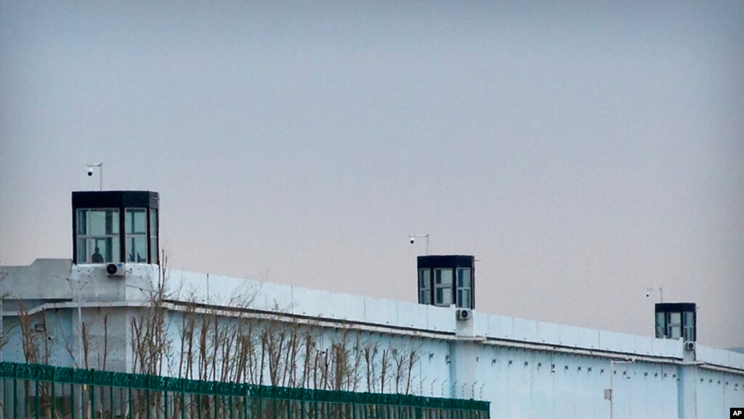FILE - A person stands in a tower on the perimeter of the No. 3 Detention Center in Dabancheng in western China's Xinjiang Uyghur Autonomous Region, April 23, 2021. 