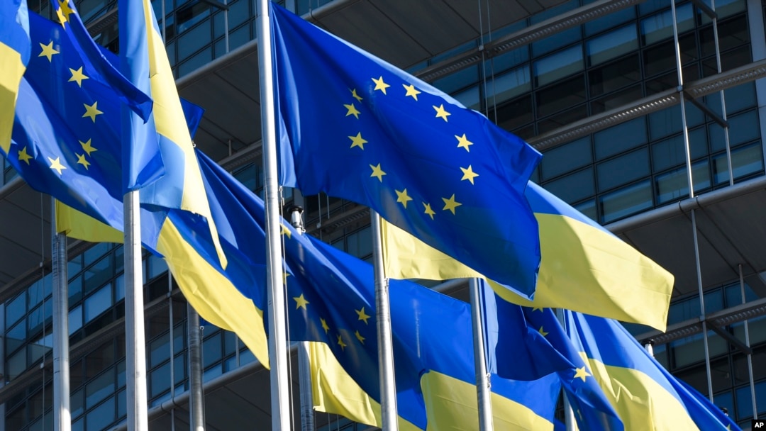 FILE - European and Ukraine flags fly outside the European Parliament, March 8, 2022 in Strasbourg, eastern France. 