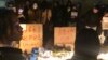 In this photo obtained by The Associated Press, demonstrators stand by protest signs in Shanghai, Nov. 26, 2022. 