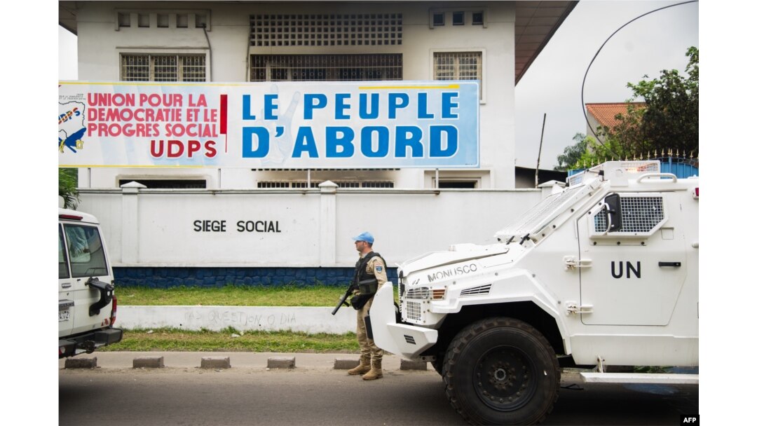 FILE - A peacekeeper of MONUSCO, the U.N. mission in the Democratic Republic of the Congo, stands guard in front of the offices of the main opposition Union for Democracy and Social Progress (UDPS) party, in Kinshasa, Sept. 20, 2016.