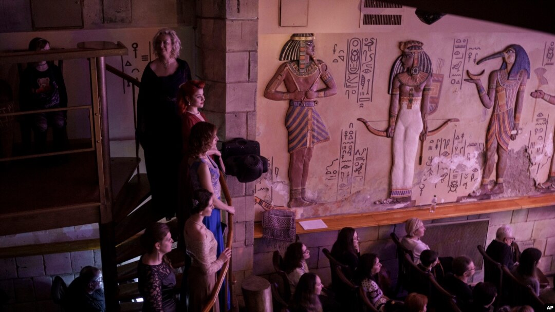 People watch as members of the Kyiv Opera Theater perform the "Christmas in Shelter" concert, on a stage underground in Kyiv, Ukraine, Dec. 24, 2022.