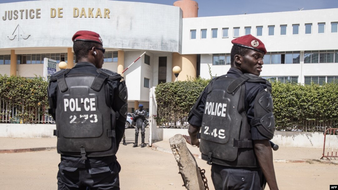 FILE - Police officers stand in front of the courthouse where opposition leader Ousmane Sonko is appearing for a hearing in Dakar, Senegal, Nov. 3, 2022. Senegalese journalist Pape Ale Niang was arrested after publishing articles about rape charges facing Sonko. 