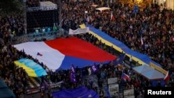 Demonstrators carry flags during a pro-government and anti-war protest rally in Prague, Czech Republic, Oct. 30, 2022. 