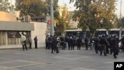 This photo taken by an individual not employed by the AP and obtained outside Iran shows police outside the Sharif University of Technology during a student protest at sparked by the death of Mahsa Amini in the custody of police, in Tehran, Oct. 7, 2022.