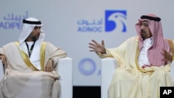 UAE Energy Minister Suhail al-Mazrouei, left, listens to Khalid al-Falih, Saudi Energy and Oil Minister, in the opening ceremony of the Abu Dhabi International Exhibition & Conference, ADIPEC, in Abu Dhabi, United Arab Emirates, Nov.12, 2018.