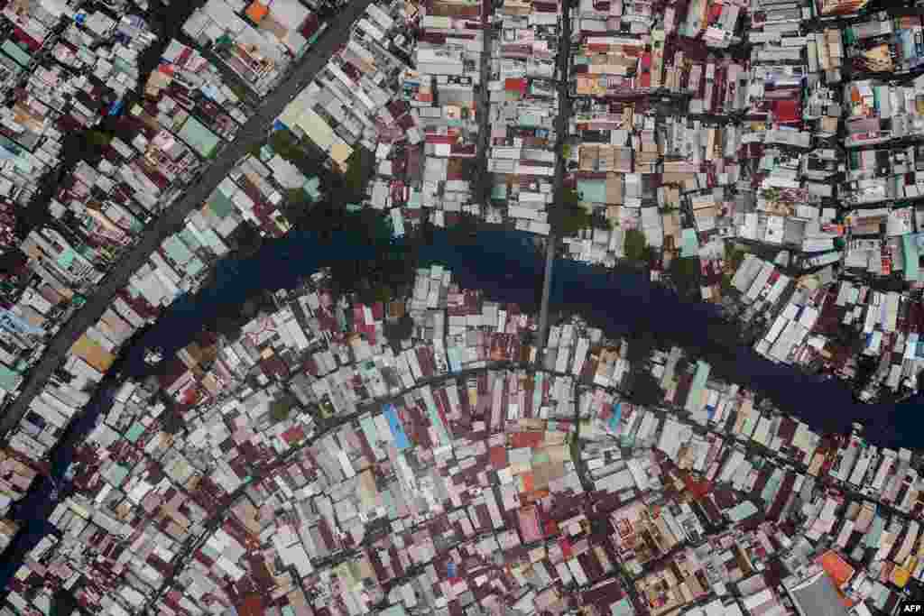 Houses are seen along the Xuyen Tam canal in Ho Chi Minh City, Vietnam. There are about 20,000 remaining households on Ho Chi Minh City's serpentine waterways slated to be demolished by 2020 as part of the city's massive renewal project. The city promises to replace some of the polluted canal banks with Parisian-style riverside promenades, paved roads, modern shops and buildings.
