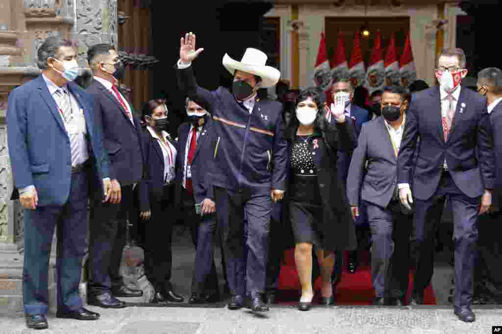 Peru&#39;s President-elect Pedro Castillo and his wife Lilia Paredes wave as they leave the Foreign Ministry to go to Congress for his swearing-in ceremony on his Inauguration Day in Lima, July 28, 2021.