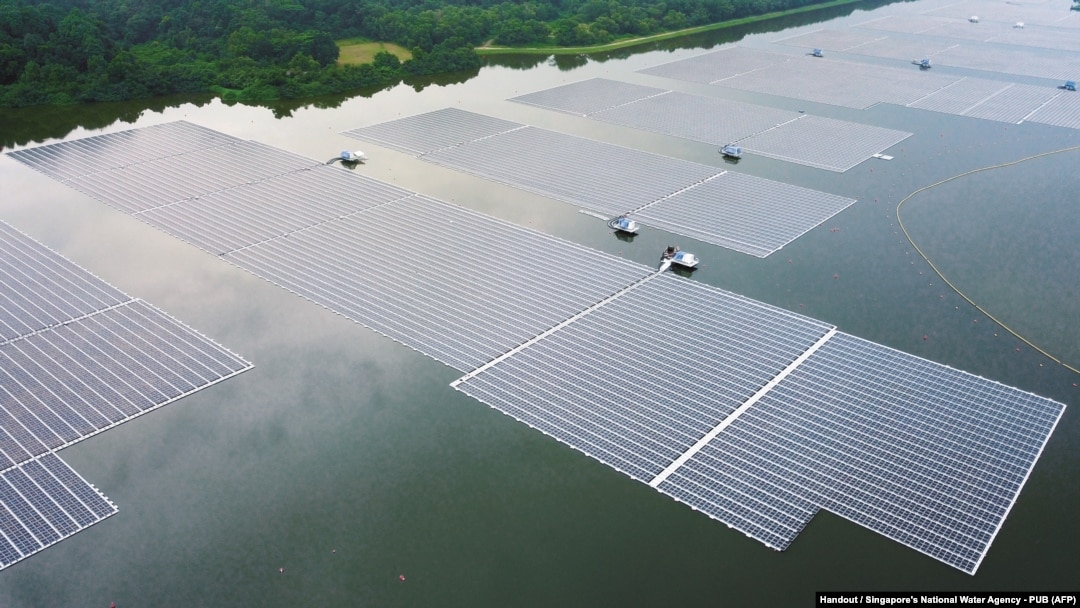 FILE - This undated handout photograph released by Singapore's national water agency PUB on July 14, 2021 shows an aerial view of Sembcorb energy company's new floating solar power farm at Tengeh reservoir in Singapore. 