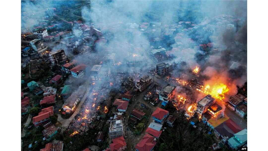 FILE - Smoke billows from properties at Thantlang in Chin State, Oct. 29, 2021, where more than 160 buildings have been destroyed caused by shelling from Junta military troops, according to local media.