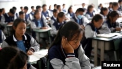 FILE - Students attend a class at the Wenchang Middle School in Yuexi county, during a government-organized media tour in Liangshan Yi Autonomous Prefecture, Sichuan province, China, Sept. 11, 2020.