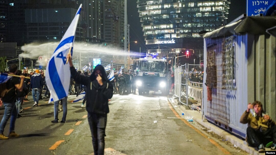 Security forces use a water cannon to disperse the people attending a demonstration against Israeli Prime Minister Benjamin Netanyahu and his nationalist coalition government's plan for judicial overhaul, in Tel Aviv, Israel, March 27, 2023.