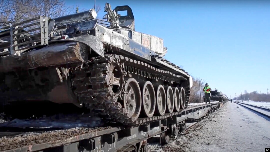 In this photo taken from video provided by the Russian Defense Ministry Press Service on Feb. 16, 2022, Russian army tanks are loaded onto railway platforms after drills in Russia.