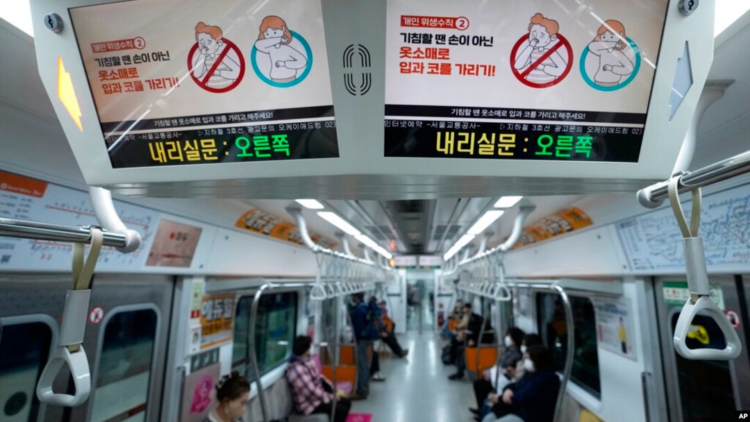 Digital screens showing safety precautions against the coronavirus are seen in a subway train in in Seoul, South Korea, March 22, 2022. 