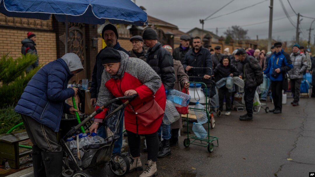 Residents queue to fill containers with drinking water in recently liberated Kherson, southern Ukraine, Nov. 20, 2022.