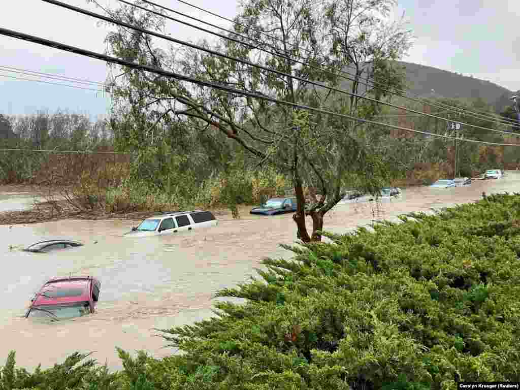 Cars are seen submerged in flood waters in Morro Bay, California, Jan. 9, 2023 in this picture obtained from social media.