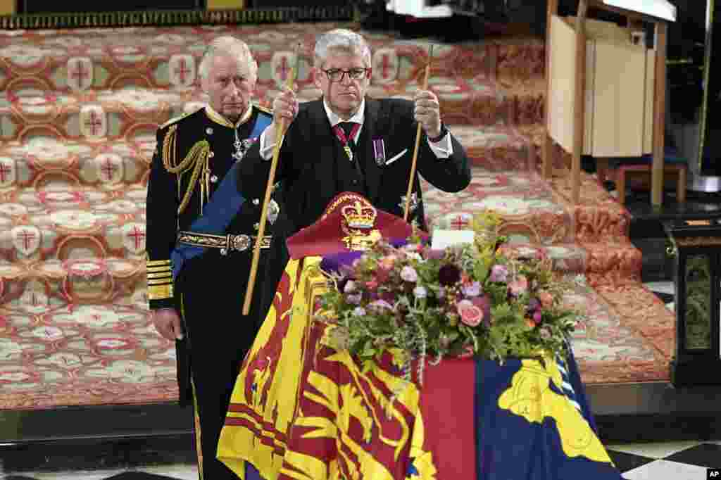 King Charles II, left, watches as The Lord Chamberlain Baron Parker breaks his Wand of Office, marking the end of his service to the sovereign, during the Committal Service for Queen Elizabeth at St. George's Chapel, Windsor Castle in Windsor, England.
