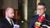 Jacek Siewiera, head of Poland's Office of National Security, left, and Polish government spokesman Piotr Muller speak after a security office meeting in Warsaw, Nov. 15, 2022. Poland put its military on alert Nov. 14 after a missile landed inside its borders, killing two people.
