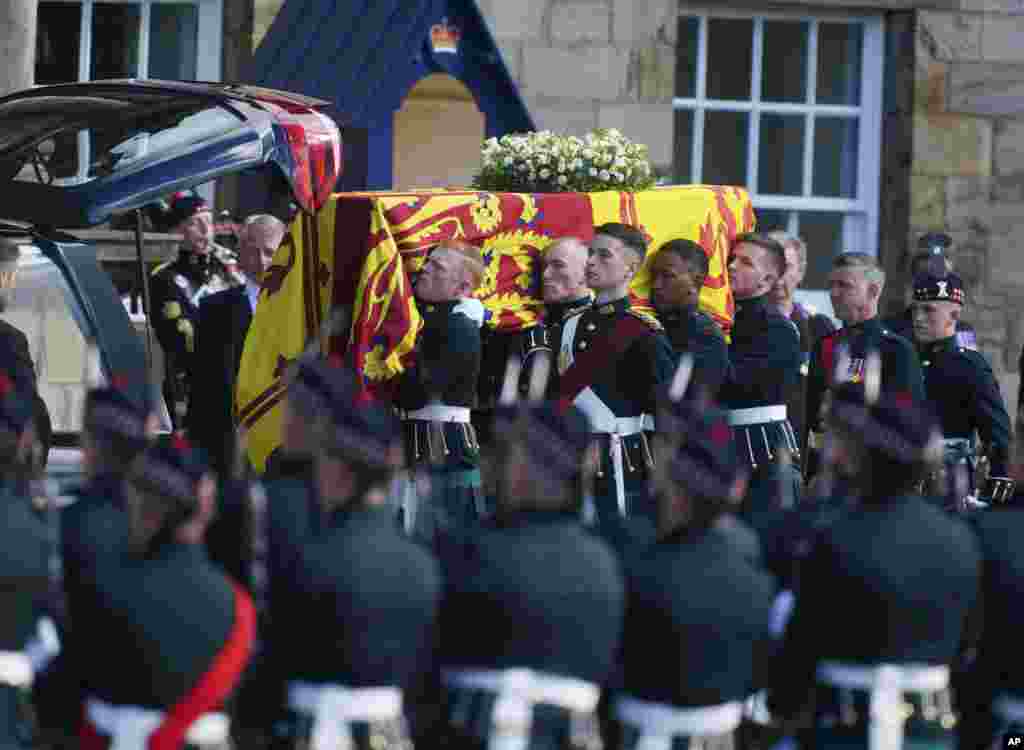 Royal guards carry Queen Elizabeth II's coffin at the start of the procession from the Palace of Holyroodhouse to St. Giles' Cathedral in Edinburgh, Sept. 12, 2022.
